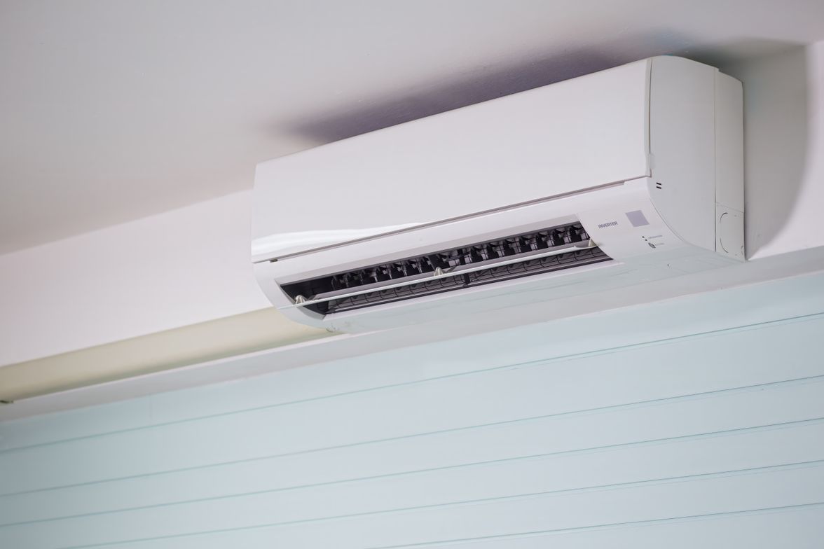 Wall-mounted ductless mini-split indoor unit installed near the ceiling of a home.